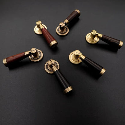 wood and brass cabinet drop pulls on a dark background
