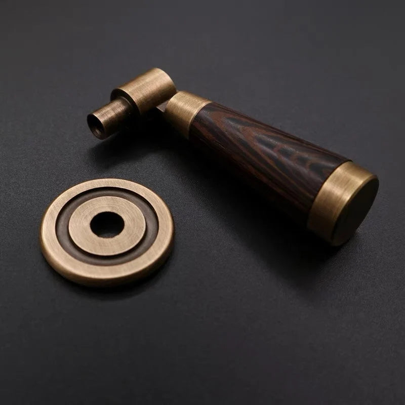 Brass and wooden handle on a dark background