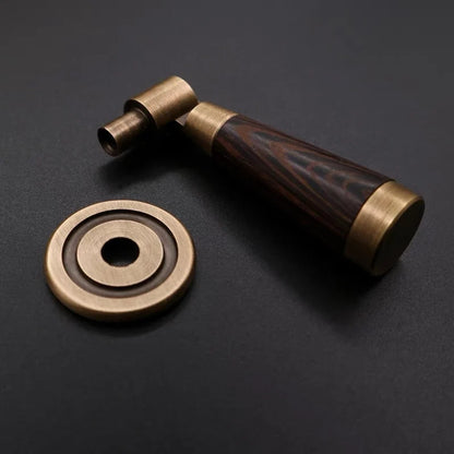 Brass and wooden handle on a dark background