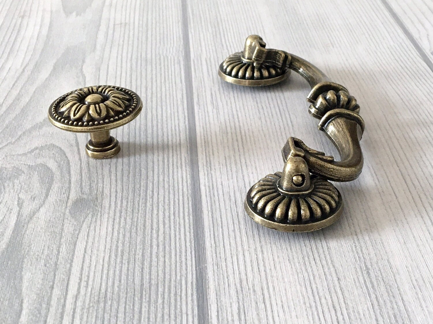ornate antique bronze swing bail pull and round floral knob