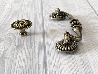 ornate antique bronze swing bail pull and round floral knob