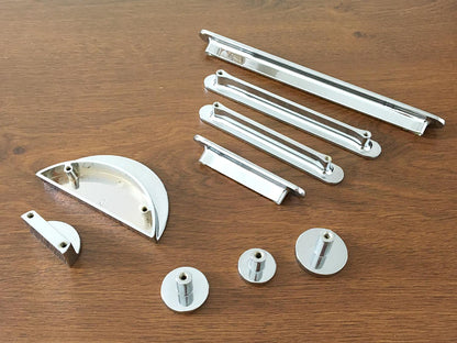 back view of metal cabinet handles and knobs on a wooden surface